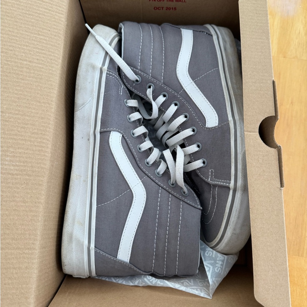 Grey high top vans.